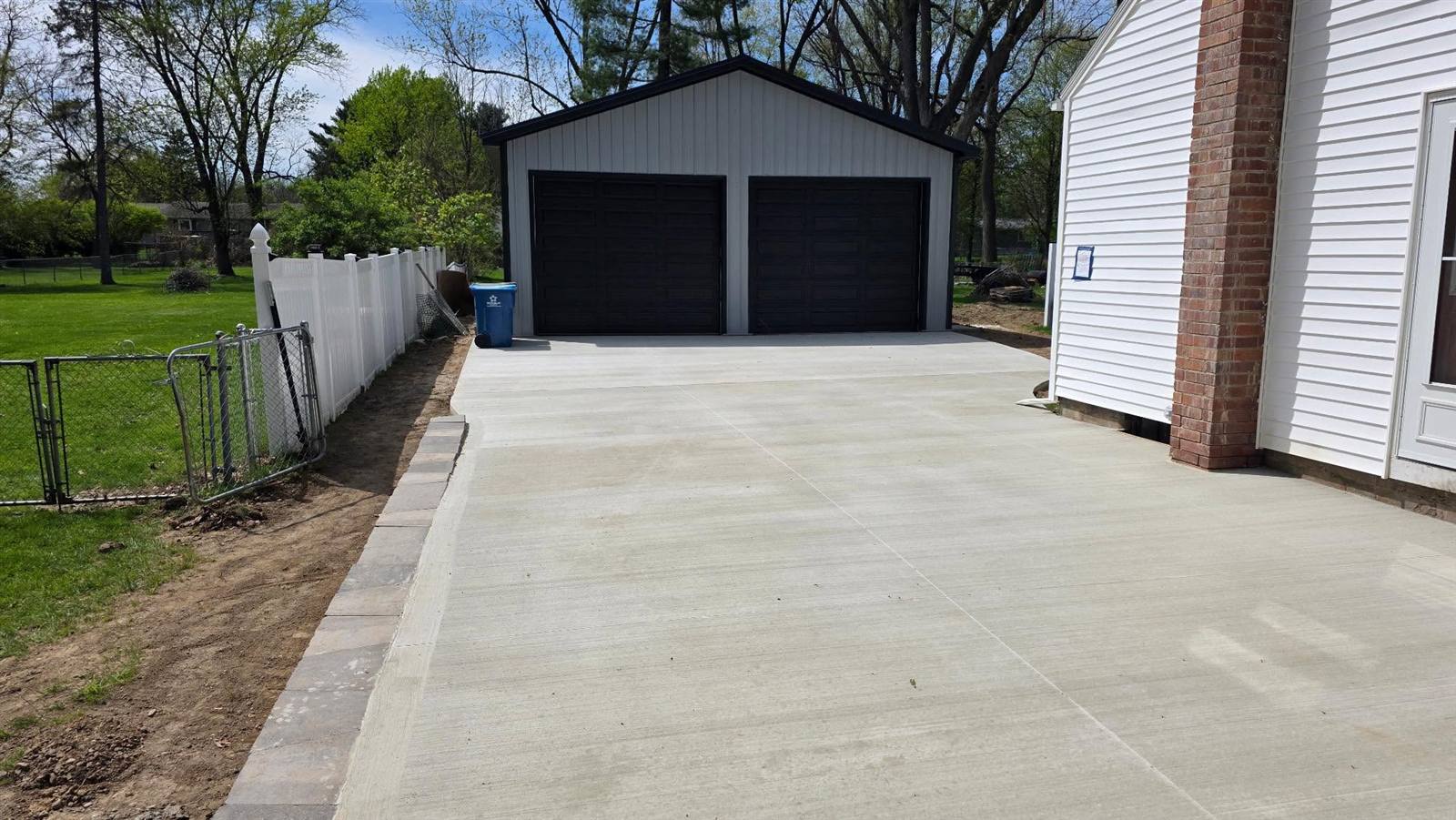 Concrete pad and driveway leading to a detached two-car garage